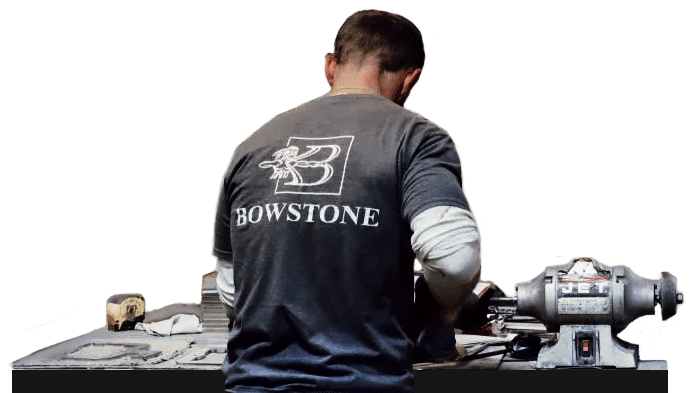 Bowstone employee using metal lathe for metal fabrication